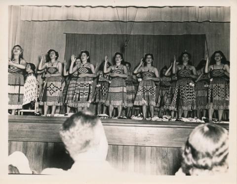 Māori poi dance in front of Marines in hall