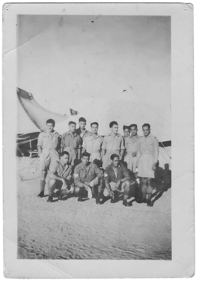 A group of soldiers in front of an aircraft