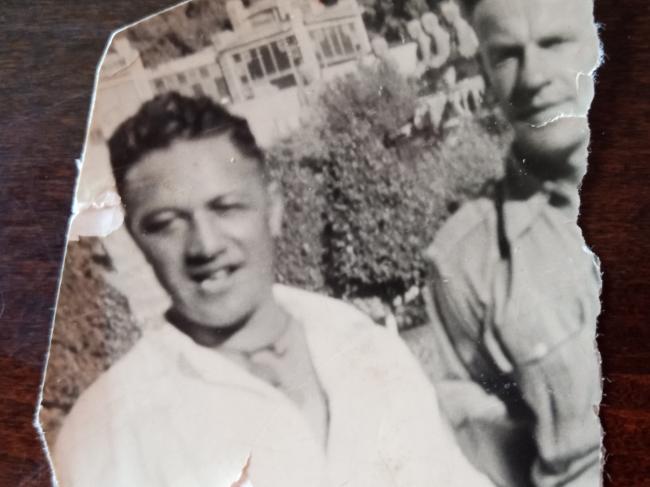 Two men in a torn photograph