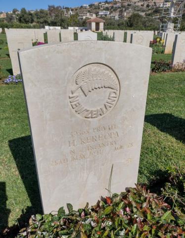 A gravestone with an engraved fern