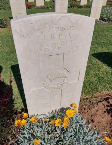 A headstone engraved with a fern