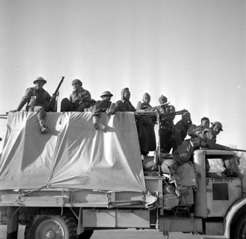 C Company men riding on a truck