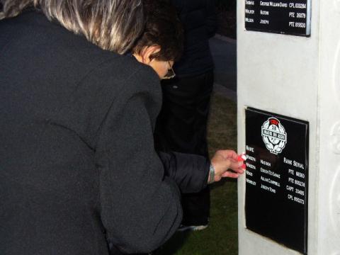 Laying a poppy at waharoa, Nelson 2011