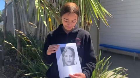 Girl holding photo of soldier